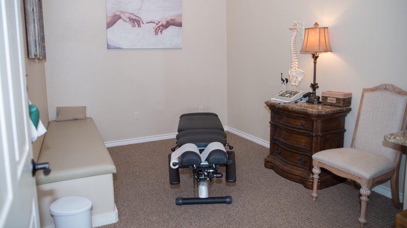Chiropractic adjustment table inside an In Motion Chiropractic treatment room