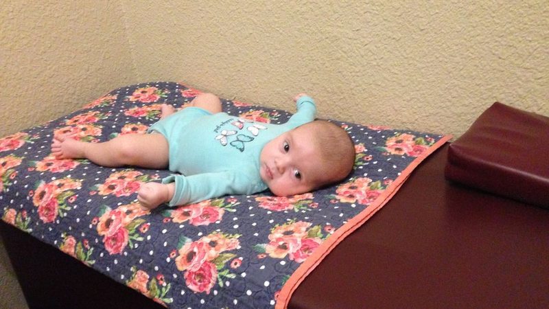 Infant patient on a treatment table at In Motion Chiropractic