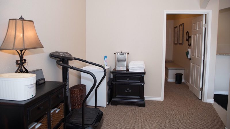 Whole-body vibration therapy platform inside an In Motion Chiropractic treatment room